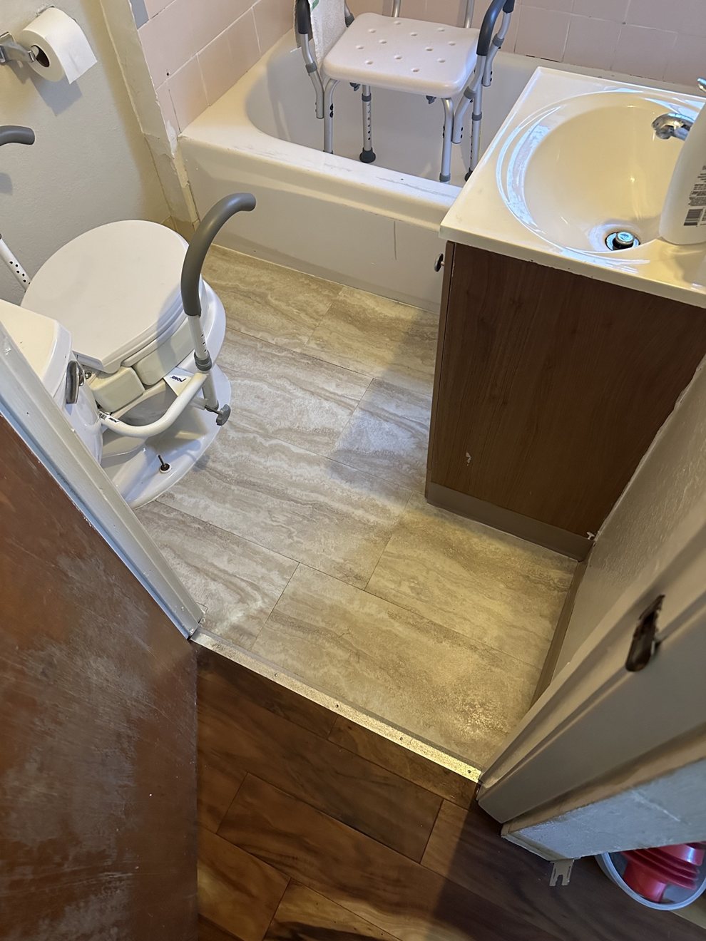 Same bathroom with new stone-look tile flooring installed