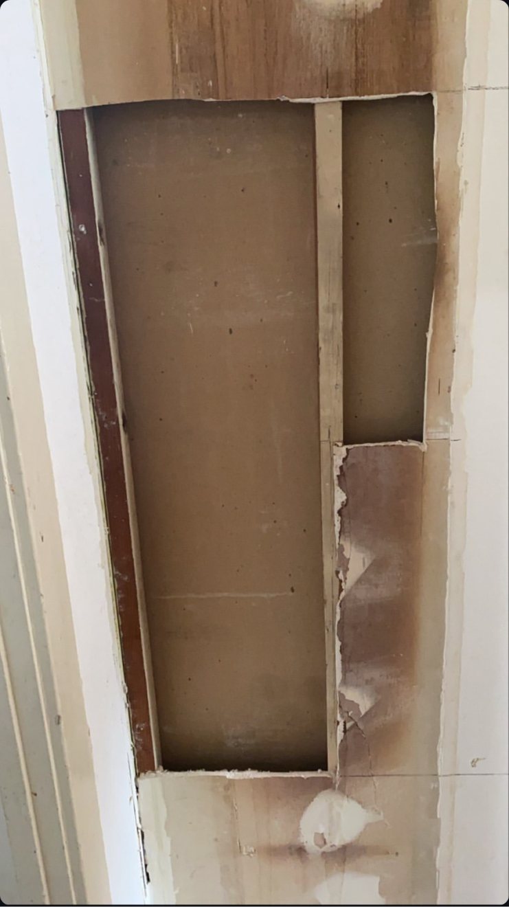 Wall opened up between studs for a drywall repair
