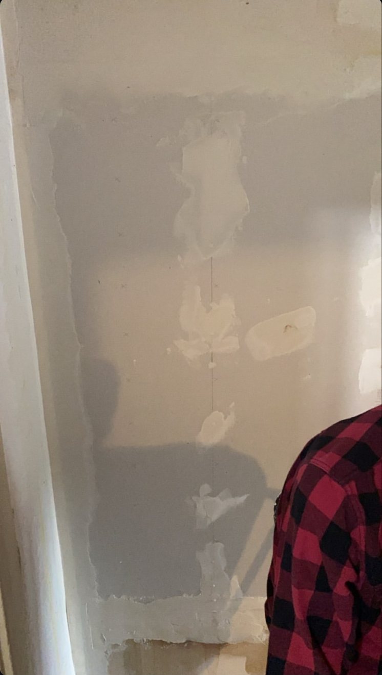 Drywall patch mudded and drying during repair