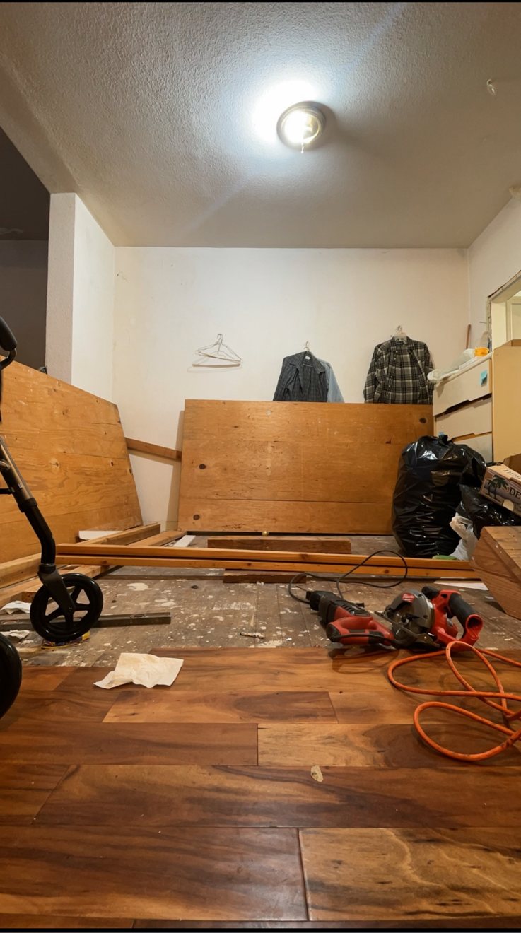 New wood flooring being installed over a subfloor