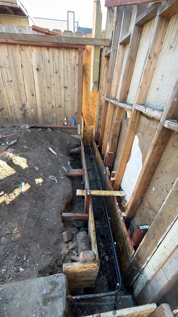 Foundation footing trench with wooden forms and rebar set