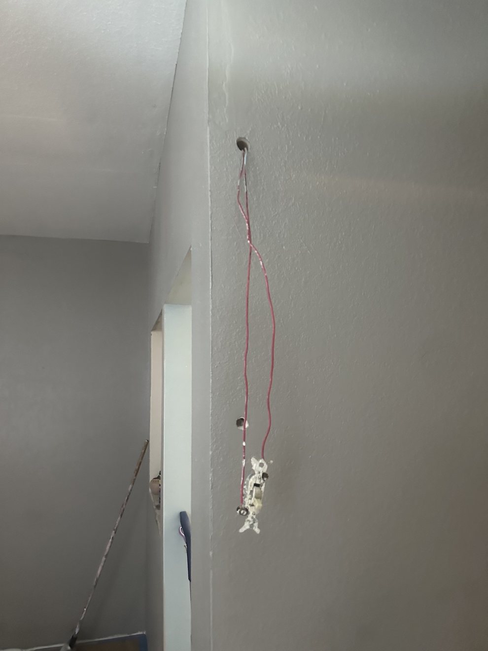 Old light switch with exposed wiring before replacement