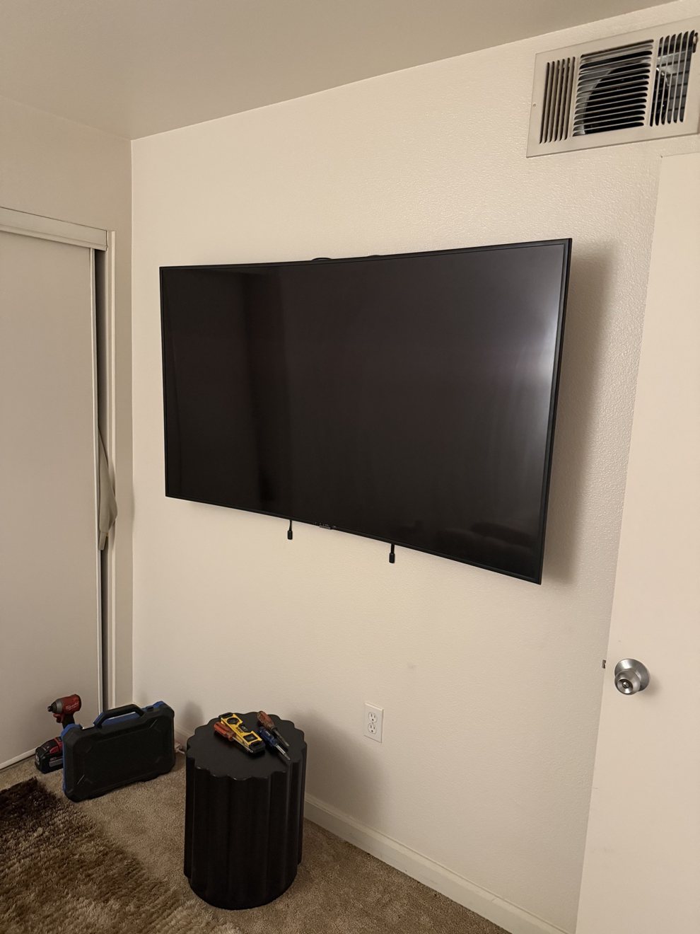 Flat-screen TV wall mounted in a bedroom