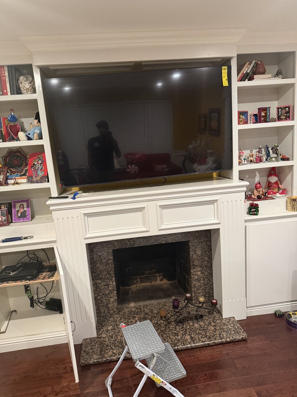 Large TV mounted above a built-in entertainment center and fireplace